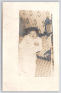 RPPC Vintage Staged Baby Shot Against Headboard Pillows Tree Real Photo Postcard