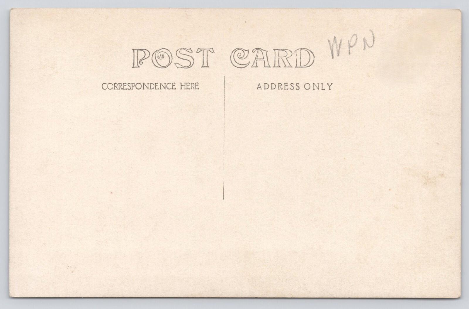 RPPC Vintage Staged Baby Shot Against Headboard Pillows Tree Real Photo Postcard